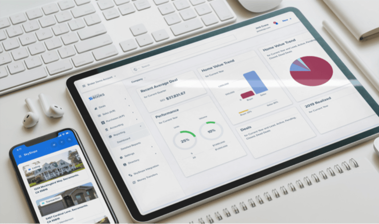 A smartphone displaying real estate listings, a table displaying market trends, a pair of wireless headphones, a keyboard, a mouse, and a notebook